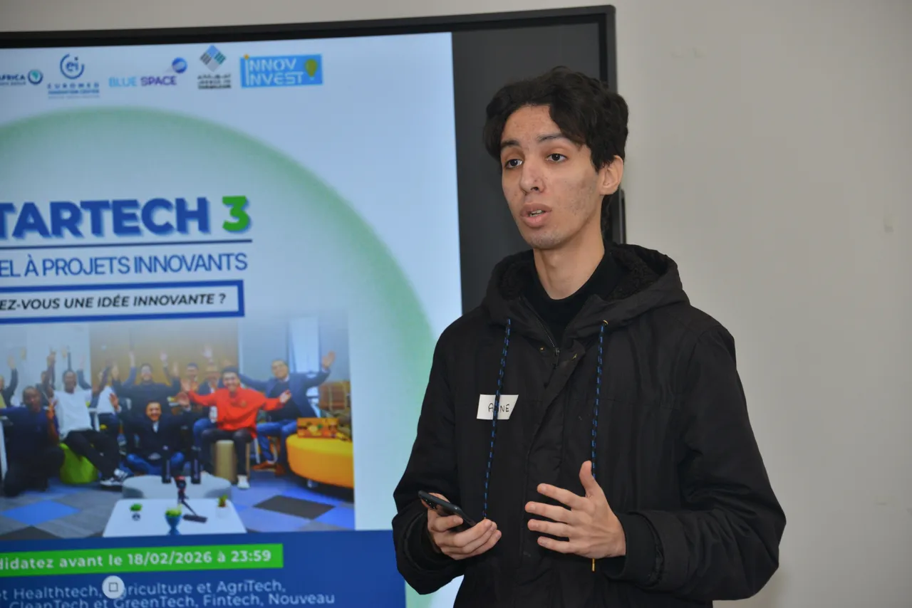 Participant pitchant son projet devant l'écran STARTECH lors du bootcamp de la 3e édition à l'EIC